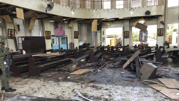 A soldier views the site inside a Roman Catholic cathedral in Jolo, the capital of Sulu province in the southern Philippines after two bombs exploded on Sunday.