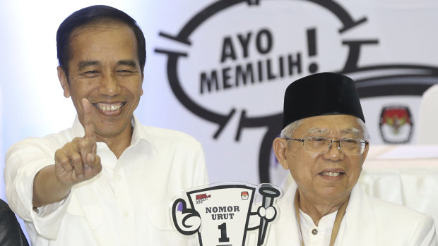 Indonesian President Joko Widodo (left) with his running mate, conservative Muslim figure Ma'ruf Amin. 