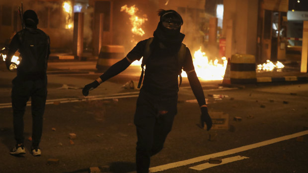 Pro-democracy protesters set fire to the toll gates to the Cross-Harbour Tunnel with Molotov cocktails in Hong Kong on Thursday.