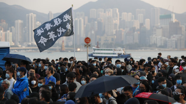 Protesters wave a flag reading "Liberate Hong Kong, the Revolution of Our Times" during the march on Sunday.