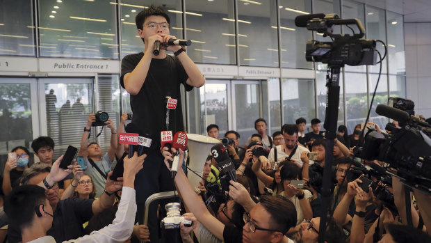Pro-democracy activist Joshua Wong speaks to protesters near the Legislative Council in Hong Kong on Monday.