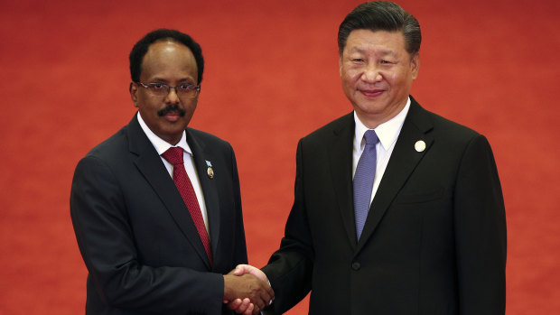 Somalia's President Mohamed Abdullahi Mohamed shakes hands with Xi Jinping.