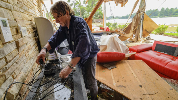 Eric Ehlenberger goes through his damaged home in New Orleans on Wednesday following a storm that swamped the city.