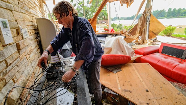 Eric Ehlenberger goes through his damaged home in New Orleans on Wednesday following a storm that swamped the city.