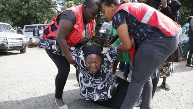 A woman grieves after learning a family member had been killed. 