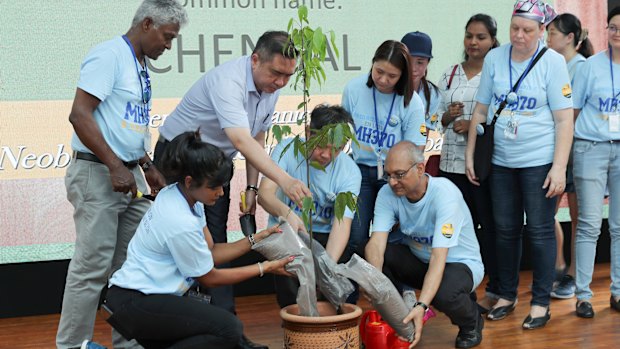 Malaysian Minister of Transport Anthony Loke, third from left, plants a tree at the Day of Remembrance event in Kuala Lumpur.