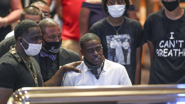 Houston rapper Cal Wayne looks at the casket of his friend, George Floyd, during a public visitation at The Fountain of Praise church in Houston. 