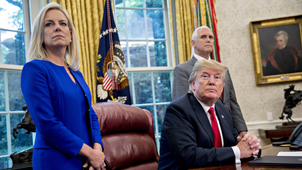 From left: US Secretary of Homeland Security Kirstjen Nielsen, President Donald Trump and Vice-President Mike Pence in the Oval Office after Trump signed the executive order.