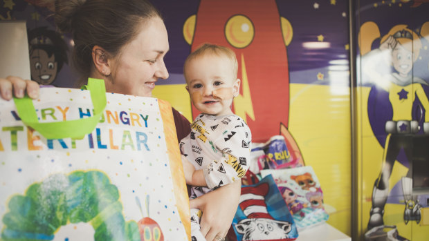 Tamryn Marek with her son Leon, 1, at Canberra Hospital, awash with showbags.
