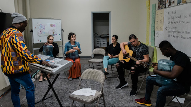 Interns and teachers play music in their down time at the International Rescue Committee in El Cajon.