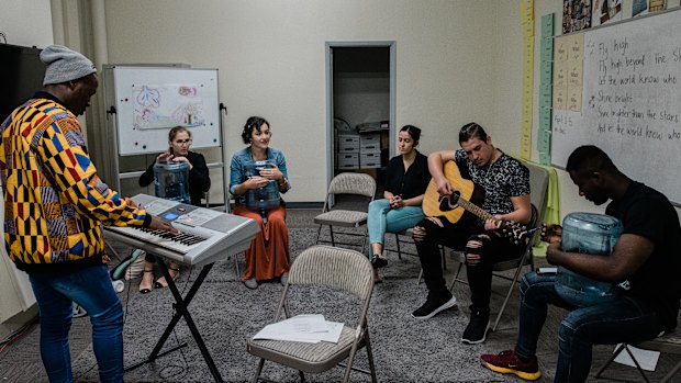 Interns and teachers play music in their down time at the International Rescue Committee in El Cajon.