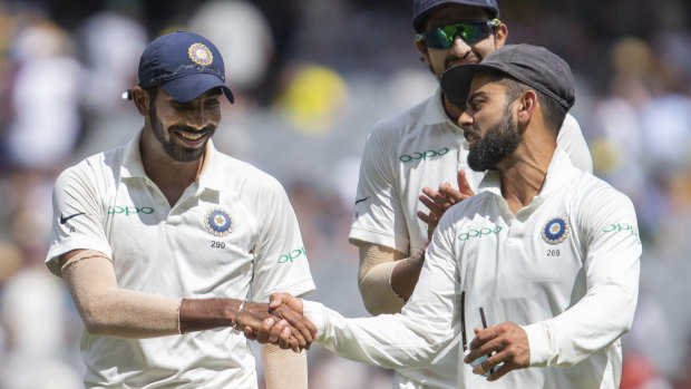 Virat Kohli, right, shakes hands with Jasprit Bumrah after the latter got six wickets during play on day three of the third Test.