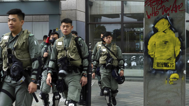 Riot policemen patrol near the government headquarters in Hong Kong on Tuesday.