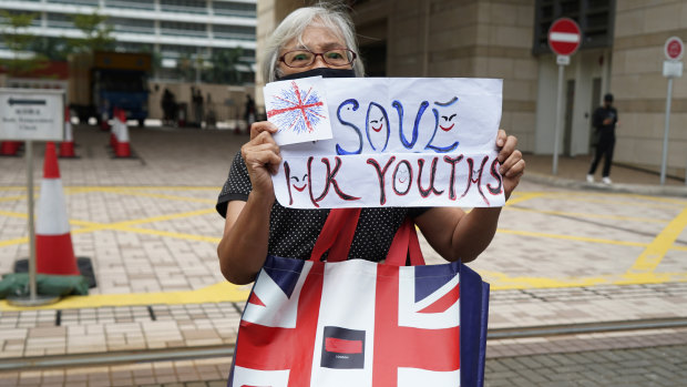 Activist Alexandra Wong chants a placard reading "Save Hong Kong Youths" outside a court, in Hong Kong in October after an activist was charged under the new law.
