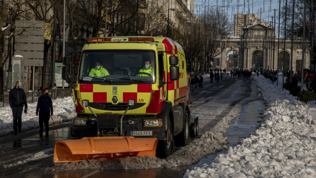 A truck mounted snow blower works at Calle de Alcala, Madrid, on Sunday.
