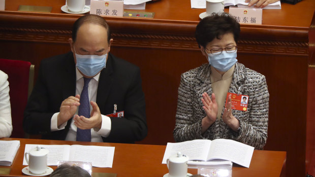 Hong Kong Chief Executive Carrie Lam, right, attends the opening session of China's National People's Congress (NPC) at the Great Hall of the People in Beijing. 