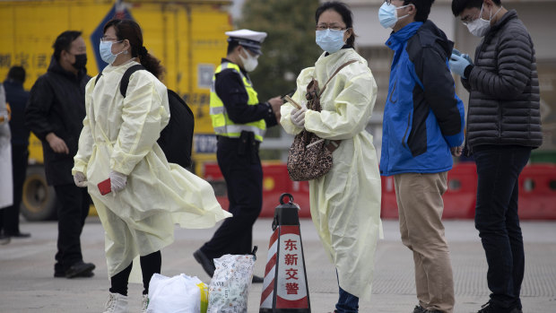 Residents of China wearing protective gear, where they are tentatively lifting restrictions. 