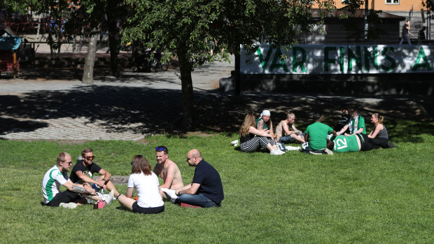 Fans of Hammarby football club socialise in a Stockholm park before a match on Sunday. 