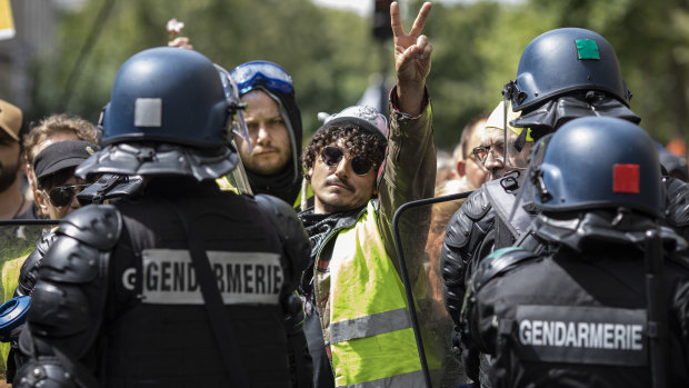 Protesters march against France’s coronavirus safety restrictions in Paris.