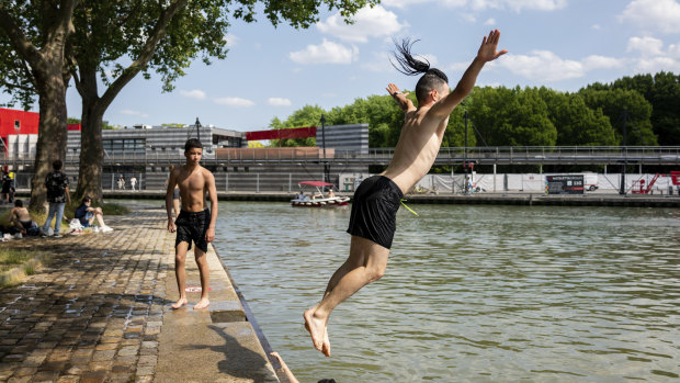 Young French people dive in the Canal de l’Ourcq in Paris.
