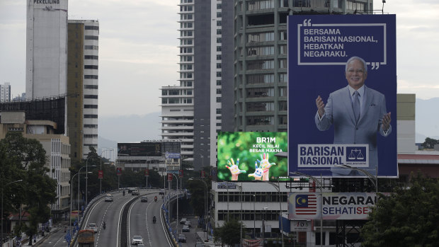 Fallen idol: A giant campaign billboard of defeated incumbent Najib Razak looms over the highways of Kuala Lumpur.
