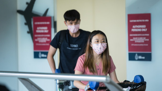 People arriving at Melbourne Airport from China on Monday wore masks amid fears of coronavirus.