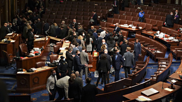 Members of Congress being evacuated from the House Chamber after Trump supporters breached the Capitol.