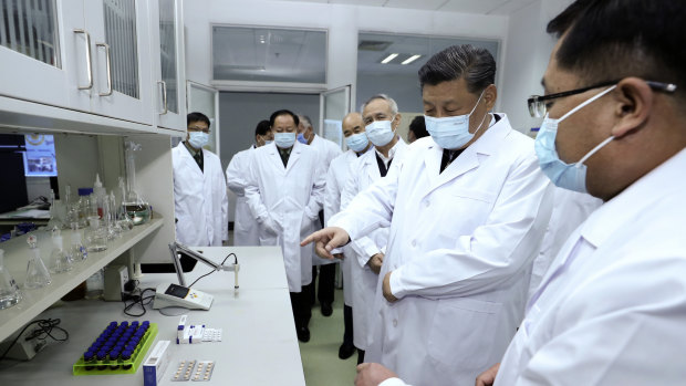 Chinese President Xi Jinping talks to medical staff at the Academy of Military Medical Sciences in Beijing.