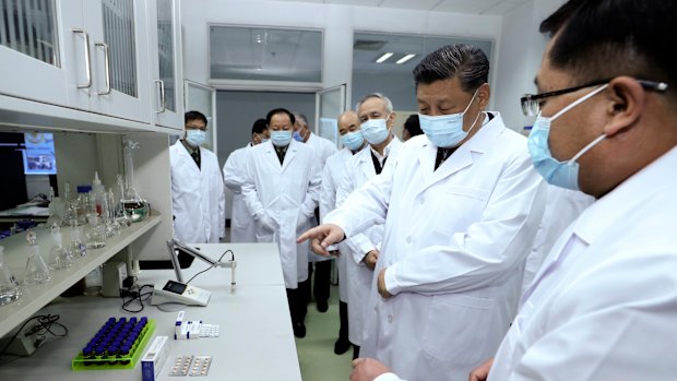 Chinese President Xi Jinping talks to medical staff at the Academy of Military Medical Sciences in Beijing.