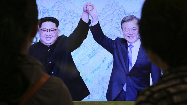 Visitors watch a screen showing the April 27  inter-Korean summit between South Korean President Moon Jae-in and North Korean leader Kim Jong-un.