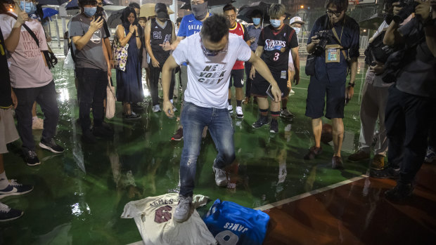 A demonstrator stomps on a LeBron James jersey during the rally.