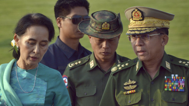 Aung San Suu Kyi, Myanmar's foreign minister and de facto leader, walks with General Min Aung Hlaing, Myanmar's commander-in-chief (right). The military has faced widespread accusations of genocide in its treatment of the country's Rohingya minority.