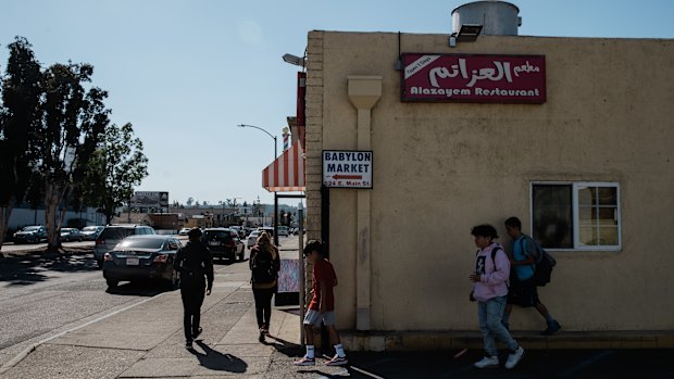 Children pass by Alazayem Restaurant in El Cajon.