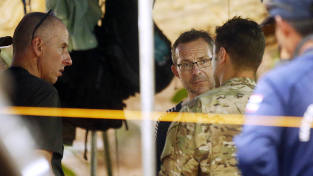 John Volanthen, center, talks to US personnel and Richard Stanton, left, in Mae Sai, Chiang Rai province, northern Thailand.