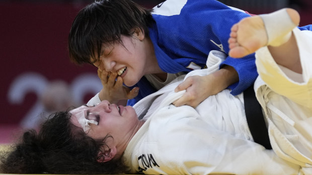 Madina Taimazova, with an injured eye, competes against Chizuru Arai of Japan in the under-70kg judo semi-final.