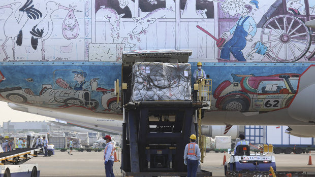 Workers unload a shipment of Pfizer vaccines from an aircraft at the Taoyuan International Airport in Taiwan.