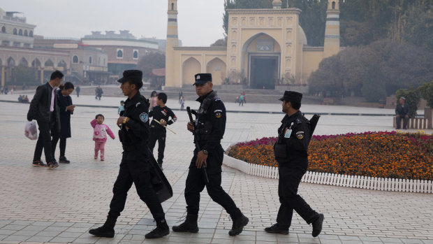 Uighur security personnel patrol near the Id Kah Mosque in Kashgar in western China's Xinjiang region.