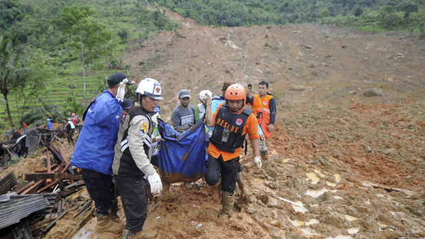 Rescuers carry the body of a landslide victim in Sirnaresmi, West Java.