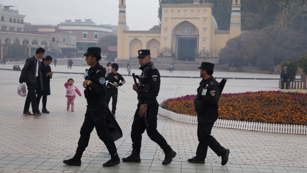 Uighur security personnel patrol near the Id Kah Mosque in Kashgar in western China's Xinjiang region.