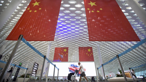 Large Chinese flags hang in Shenzhen Baoan International Airport. China is marking the 40th anniversary of the Reform and Opening Up Policy, a program of economic liberalisation that led to the creation of special economic zones, such as the one in Shenzhen. 
