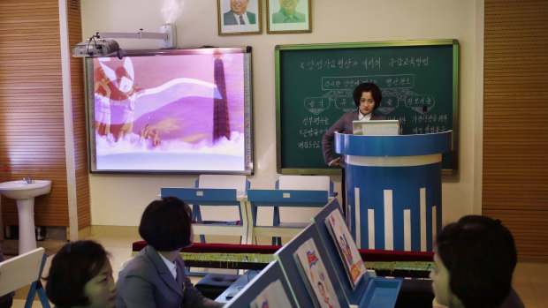 A computer generated video of North Korean flag is projected onto a screen during a multimedia class at Pyongyang Teachers' University.