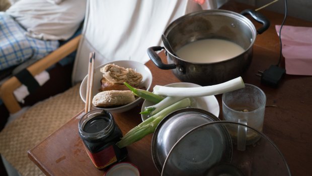 Han's breakfast: soy milk, Chinese buns, a roasted chicken leg and some spring onion with fermented bean curd dip. 