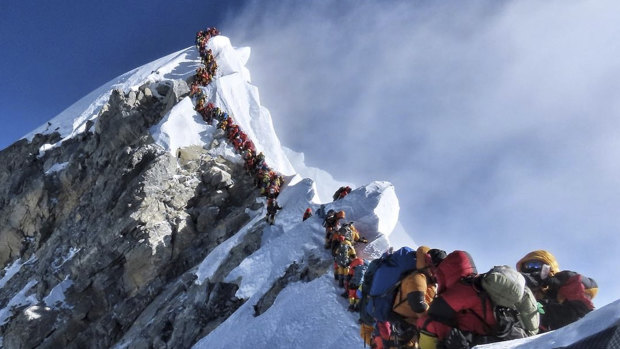 A photo of climbers lining up at the summit of Mount Everest in May 2019.