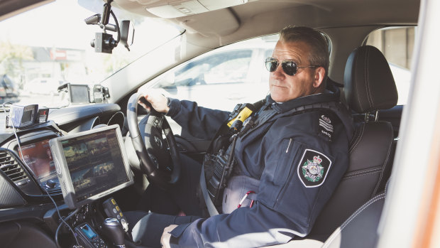 The head of ACT's road safety operations team, Sergeant Marcus Boorman, with the new traffic car technology.