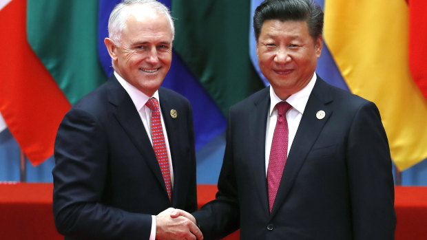 Prime Minister Malcolm Turnbull, left, shakes hands with China's President Xi Jinping before a group photo session for the G20 Summit held at the Hangzhou International Expo Centre in Hangzhou.