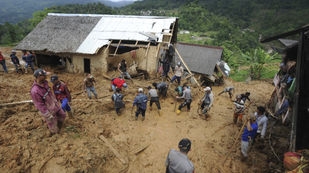 Rescuers search for victims at a village hit by the landslide.