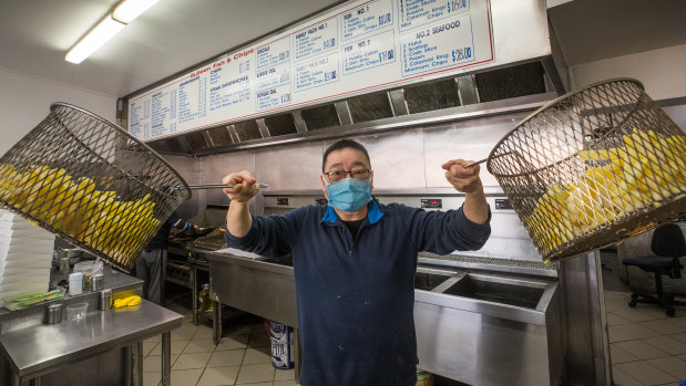 John Tang at Bulleen Fish and Chips prepares for the traditional Good Friday rush despite the coronavirus outbreak.  