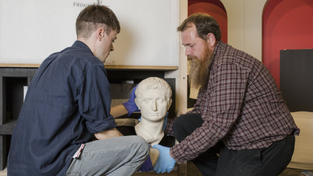 From left, Assistant collections manager, heavy objects Damien Hart, and collections manager, heavy objects Darrel Day both of the British Museum, with the head of Augustus Caesar, Rome's first emperor.