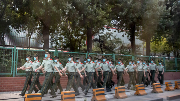 Chinese paramilitary police march in formation outside the Xinfadi wholesale food market after it was closed due to a coronavirus outbreak.