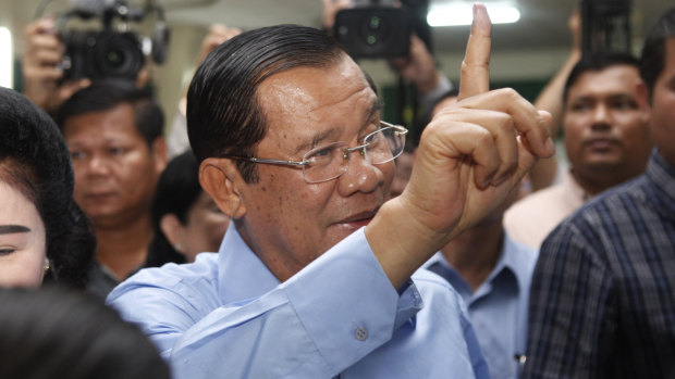 Cambodian Prime Minister Hun Sen shows off his inked finger after voting south-east of Phnom Penh on Sunday.